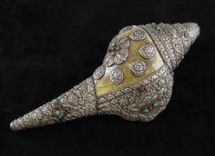 A Tibetan silver mounted conch shell, 15.5in. (39cm), repair A Tibetan silver mounted conch shell,