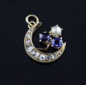 A gold, sapphire, diamond and split pearl set crescent pendant, 0.5in. A gold, sapphire, diamond and