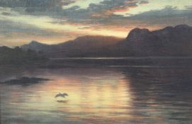 Joseph Farquharson (1847-1935) Sunset over a loch with a heron in flight, 12 x 18in. Joseph