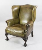A pair of green leather wingback armchairs, A pair of green leather wingback armchairs, with brass