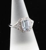 An 18ct white gold, aquamarine and diamond set dress ring, size M. An 18ct white gold, aquamarine