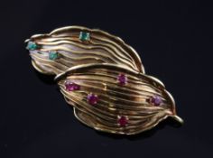 A 18ct gold ruby and emerald set double leaf brooch, 2in. A 18ct gold ruby and emerald set double