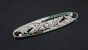 A 1920`s gold, silver, diamond and emerald set bar brooch, 2in. A 1920`s gold, silver, diamond and
