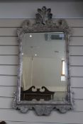 A George I design silvered wall mirror, W.3ft 5in. A George I design silvered wall mirror, with