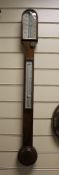 A Victorian walnut stick barometer, 36in. A Victorian walnut stick barometer, with ivory scale and