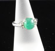 A white gold, cabochon emerald and diamond set dress ring, size M. A white gold, cabochon emerald