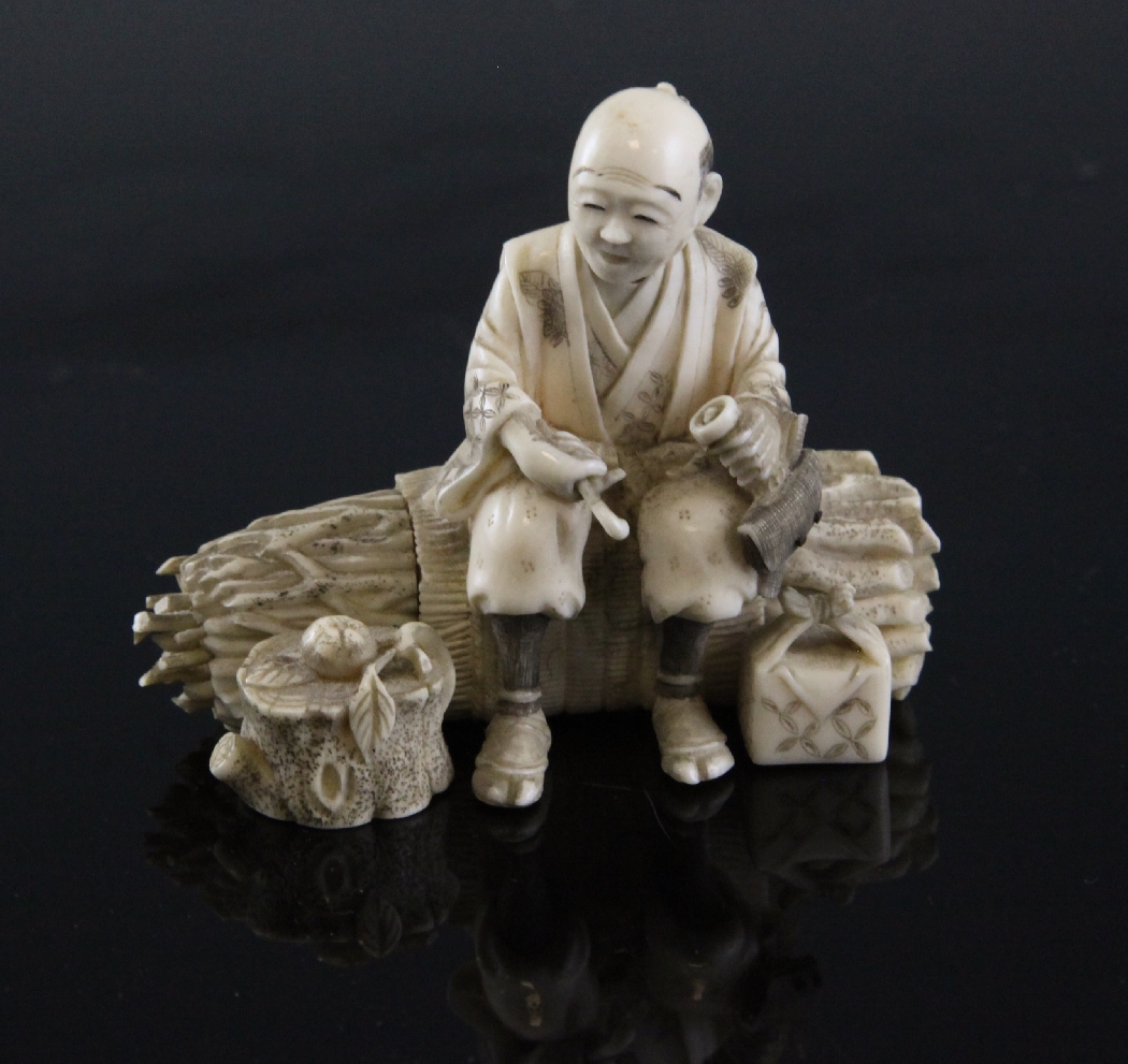 A Japanese sectional ivory figure of a seated woodcutter, Meiji period, 2.75in. A Japanese sectional