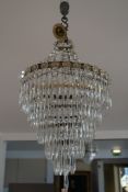 A brass and glass lustre hung graduated five tier chandelier, approx. 13in. A brass and glass lustre