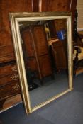 A pair of painted and parcel gilt rectangular overmantel mirrors, 4ft 4in. x 3ft 3in. A pair of