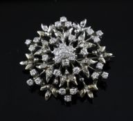 A white gold and diamond cluster brooch, 1.25in. A white gold and diamond cluster brooch, of