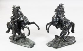 After Guillaume Coustou. A pair of 19th century patinated bronze Marly horse groups, 23in. After