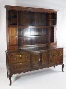A George III oak dresser, W.5ft 11in. A George III oak dresser, the back with open plate rack