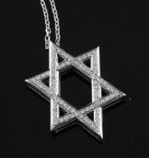 A white gold and diamond set Star of David pendant, pendant 1in. A white gold and diamond set Star