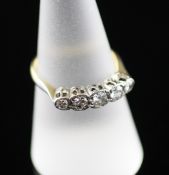 An 18ct gold and platinum graduated five stone half hoop ring, size O. An 18ct gold and platinum