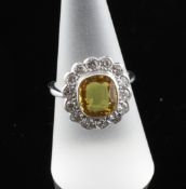 An 18ct white gold yellow sapphire and diamond set dress ring, size P. An 18ct white gold yellow