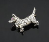 An early 20th century gold, silver, diamond and cabochon ruby set dog brooch, 0.75in. An early