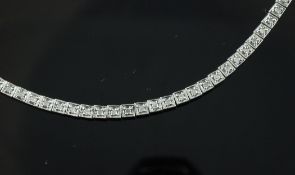 A modern 9ct white gold and diamond set line bracelet, 7in. A modern 9ct white gold and diamond