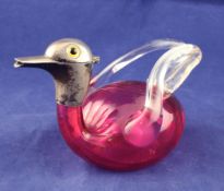 An Edwardian novelty silver mounted cranberry and clear glass liqueur jug, modelled as a duck,