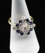 A 1980`s 18ct gold, sapphire and diamond set cluster dress ring, size L. A 1980`s 18ct gold,
