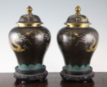 A pair of Chinese cloisonne enamel `dragon` vases and covers, early 20th century, 9.25in. (23.