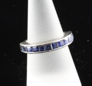 An 18ct white gold and sapphire half eternity ring, size O. An 18ct white gold and sapphire half