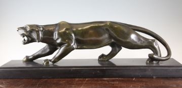 A large Art Deco patinated bronze model of a panther, 10in., length 29.5in. A large Art Deco