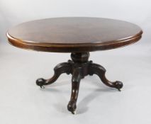 A Victorian oval walnut loo table, W.4ft 9in. A Victorian oval walnut loo table, with central