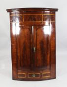 An early 19th century hanging corner cupboard, H.4ft 2in. An early 19th century mahogany and