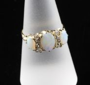 A gold and three stone white opal and diamond cluster dress ring, size O. A gold and three stone