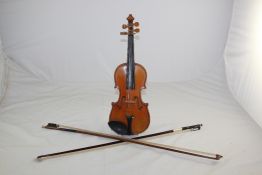 A 19th / 20th century quarter size violin & 2 bows A 19th / 20th century quarter size violin, with