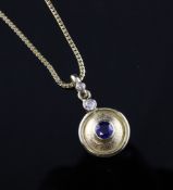 A modern 9ct gold, sapphire and diamond disc pendant, pendant 1.5in inc. bale. A modern 9ct gold,