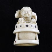 A Japanese ivory and lacquer inlaid netsuke of three oni, early 20th century, 1.9in. A Japanese