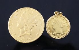 An 1899 USA twenty dollar gold coin and a gold coin type pendant. An 1899 USA twenty dollar gold