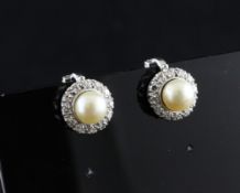 A pair of platinum, diamond and cultured pearl cluster ear clips. A pair of platinum, diamond and