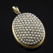 A gold and multi split pearl set oval pendant locket, 2in. A gold and multi split pearl set oval