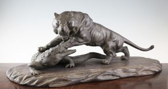 A good large Japanese bronze model of a tiger fighting a crocodile, Meiji period, 26.25in. A good