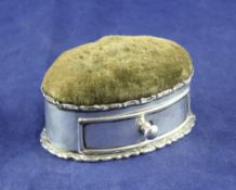 An Edwardian silver mounted oval pin cushion, 3.25in. An Edwardian silver mounted oval pin