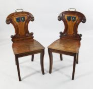 A pair of early 19th century mahogany hall chairs A pair of early 19th century mahogany hall chairs,