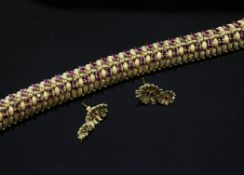 An 18ct gold and ruby set articulated bracelet & pair of earrings. An 18ct gold and ruby set