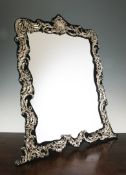 A large Edwardian repousse silver mounted easel mirror by William Comyns, overall height 27in. A