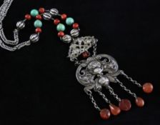 A Tibetan necklace A Tibetan silver, coral and hardstone necklace, the pendant modelled as a bat and