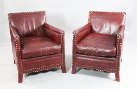 A pair of burgundy leather and brass studded club armchairs, A pair of burgundy leather and brass
