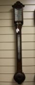 A Victorian carved walnut stick barometer, 40in. A Victorian carved walnut stick barometer, with