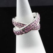 A stylish white gold, pink sapphire and diamond set X-shaped dress ring, size K. A stylish white