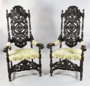 A pair of carved oak 17th century style open armchairs, A pair of carved oak 17th century style open