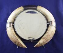 An early 20th century silver plate and twin boar`s tusk mounted easel mirror, 15in. An early 20th