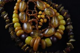 Three amber necklaces and two amber coloured necklaces, 36in et infra. Three amber necklaces and two
