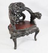 A Japanese dragon carved tub shaped armchair, A Japanese dragon carved tub shaped armchair, with
