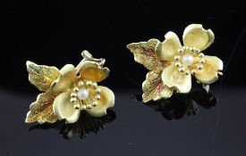 A pair of gold and cultured pearl set ear clips of floral design, 1in. A pair of gold and cultured