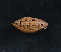 A Chinese peach stone carving of a boat, approx. 1.75in. (4.5cm) A Chinese peach stone carving of